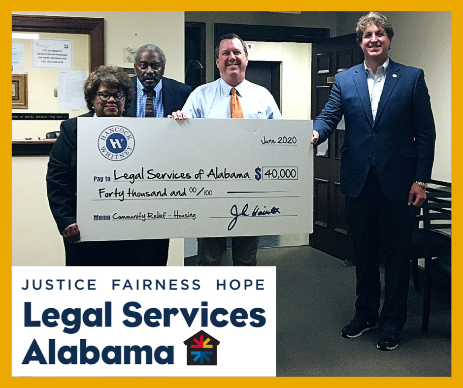 Photo of attorneys at Mobile office receiving a check from Hancock Whitney Bank